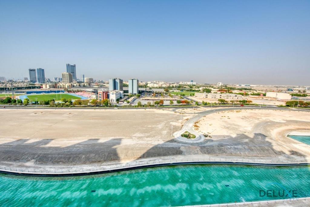 Дубай: Sunny 1BR at Canal Residences West Dubai Sports City by Deluxe Holiday Homes