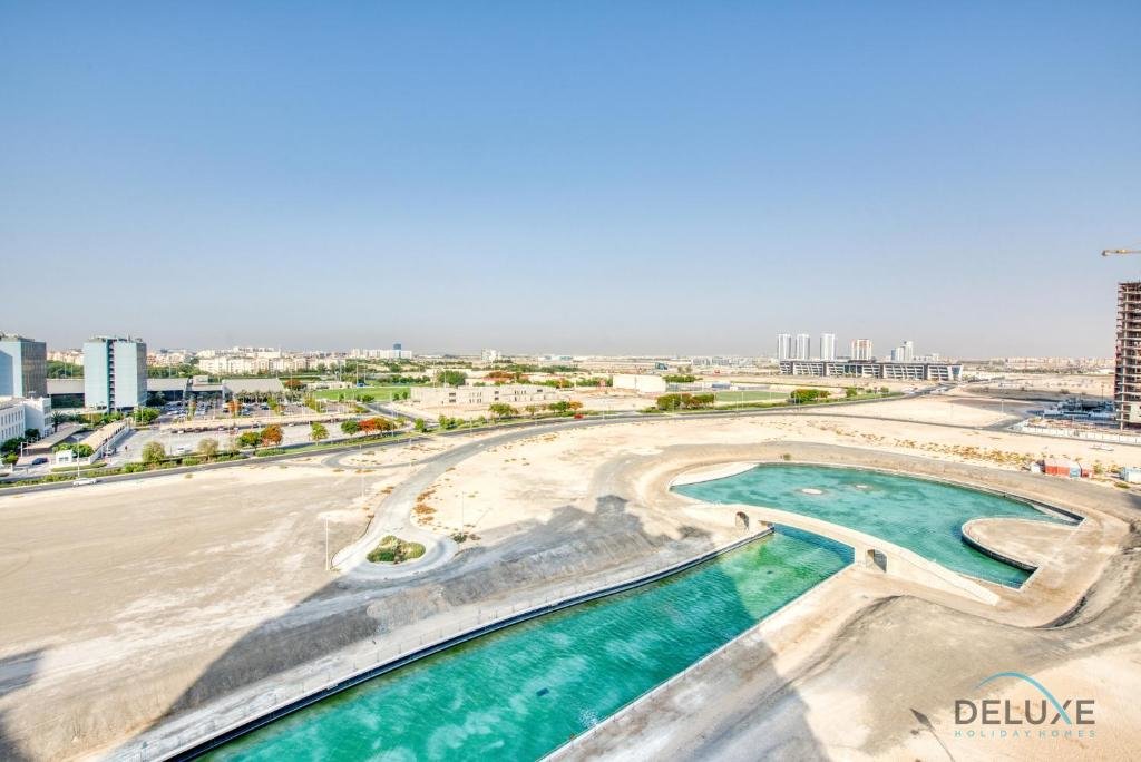 Дубай: Sunny 1BR at Canal Residences West Dubai Sports City by Deluxe Holiday Homes