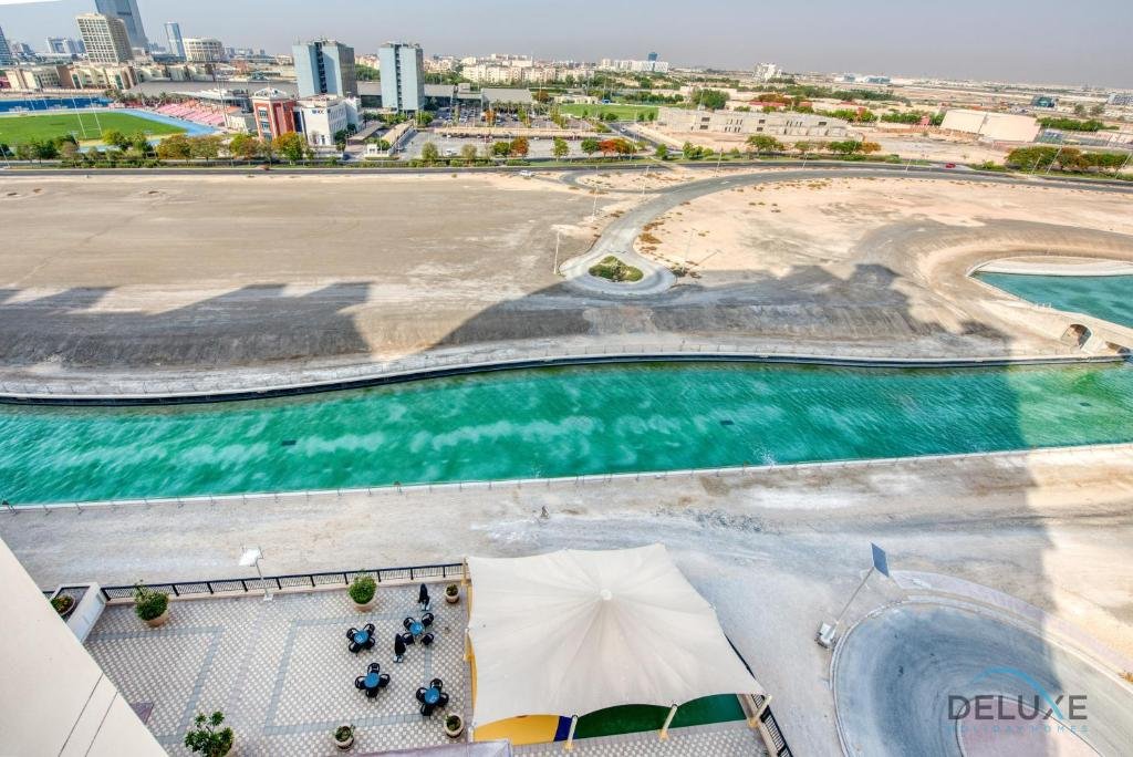Дубай: Sunny 1BR at Canal Residences West Dubai Sports City by Deluxe Holiday Homes